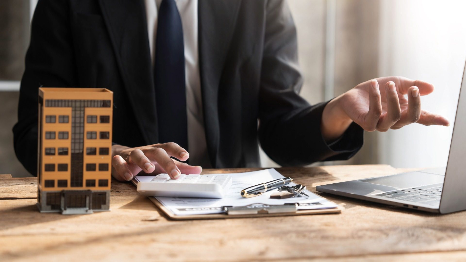 Reviewing financial documents and commercial property plans to decide whether to sell business before property