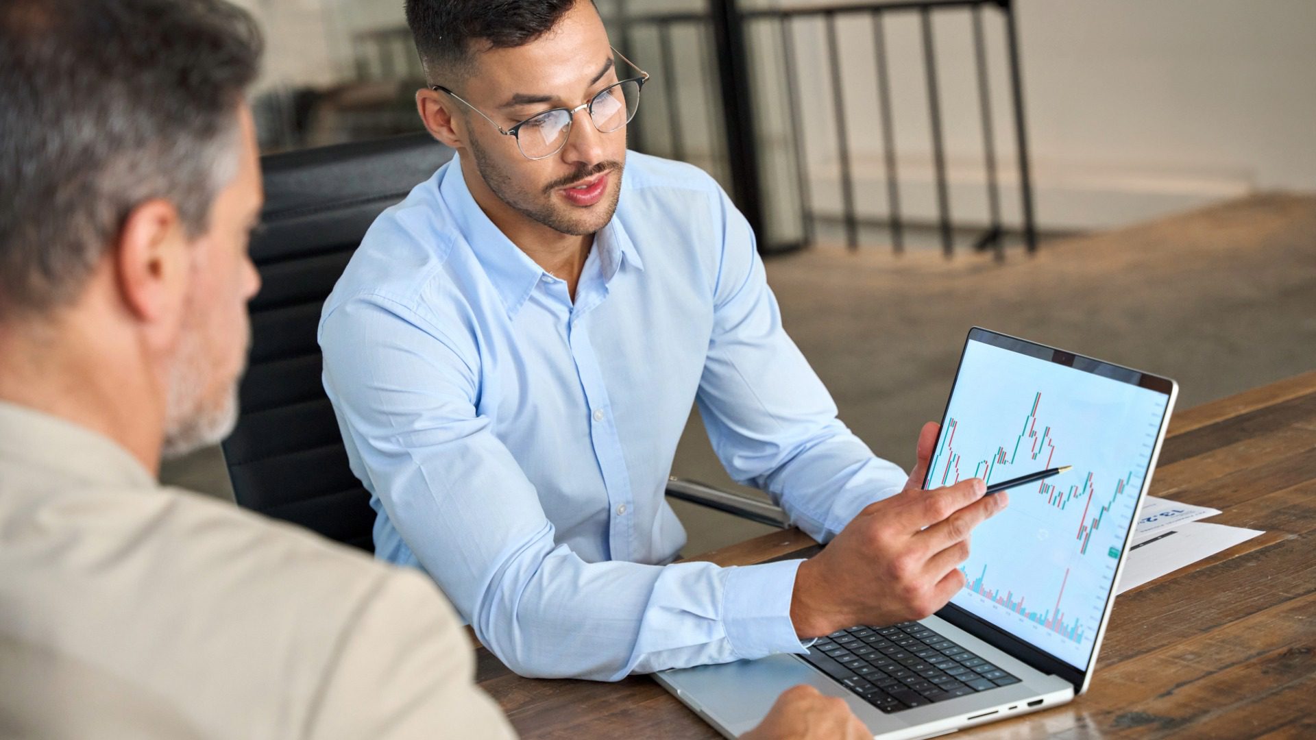 2026-stock sale in business Business buyer and seller reviewing documents and signing agreement during a stock sale in a business transaction