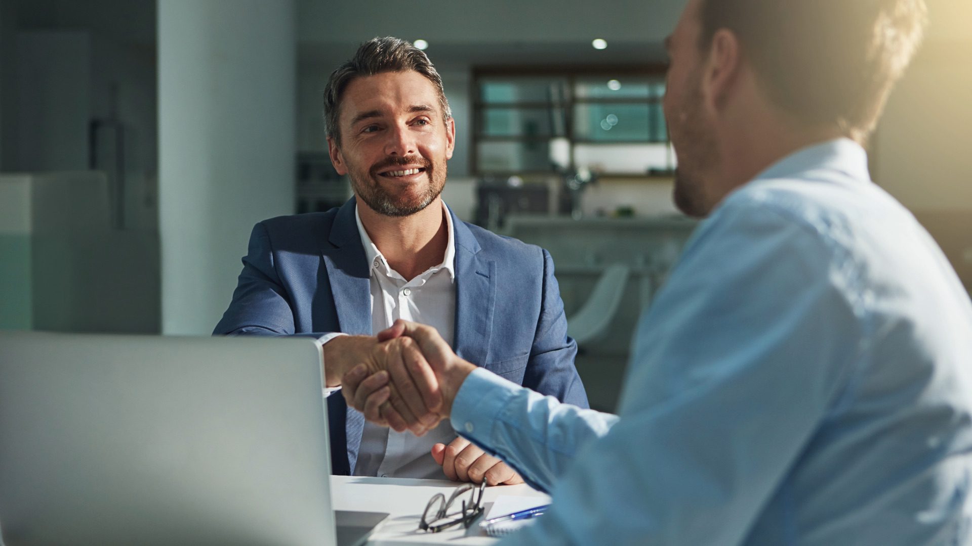 Prospective business buyer meeting with a business broker to discuss purchasing a company