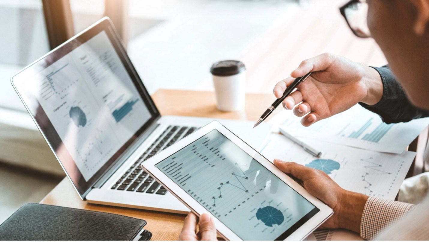 Business owner reviewing valuation multiples and financial analysis with an M&A advisor.
